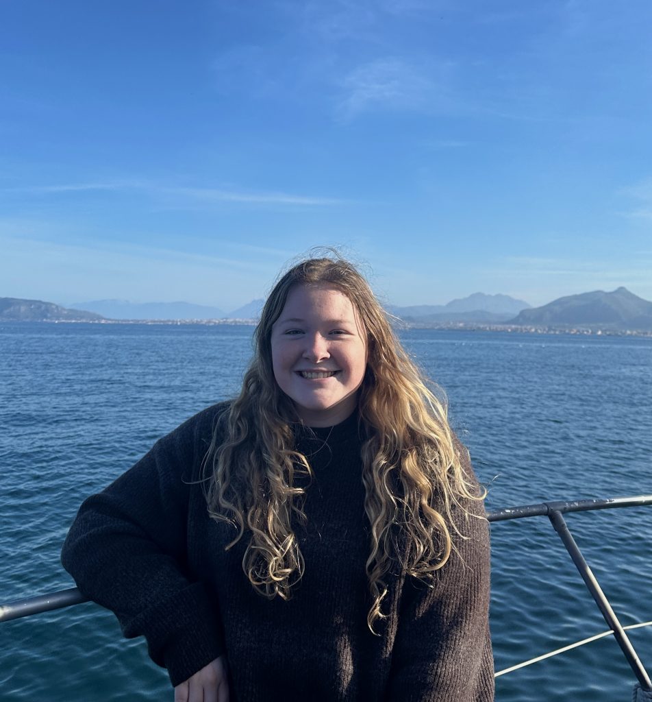 Image of Abigail Healy with water and mountains in the background.