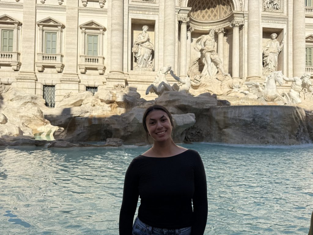Image of Avery Fournier in front of a body of water and building.