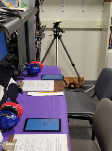 Setup of the study with tablets, paperwork, and headphones