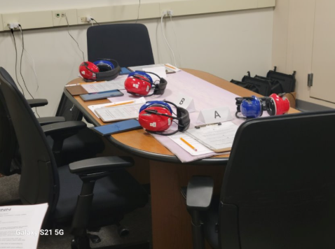 Setup of the study with tablets, paperwork, and headphones
